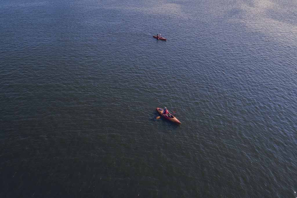Aerial view of two kayaks paddling on a river